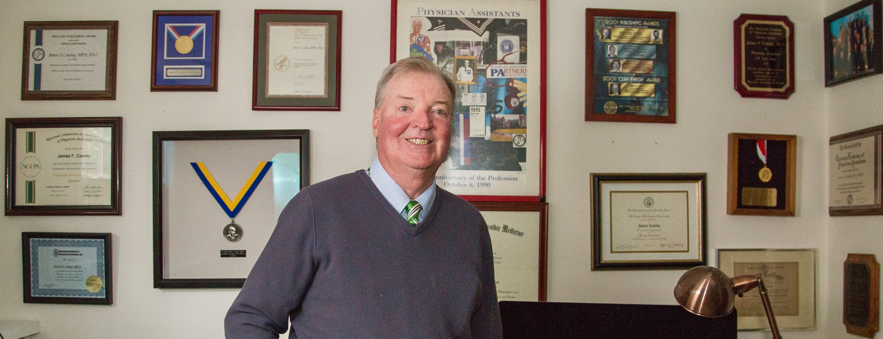 Jim Cawley surrounded by awards