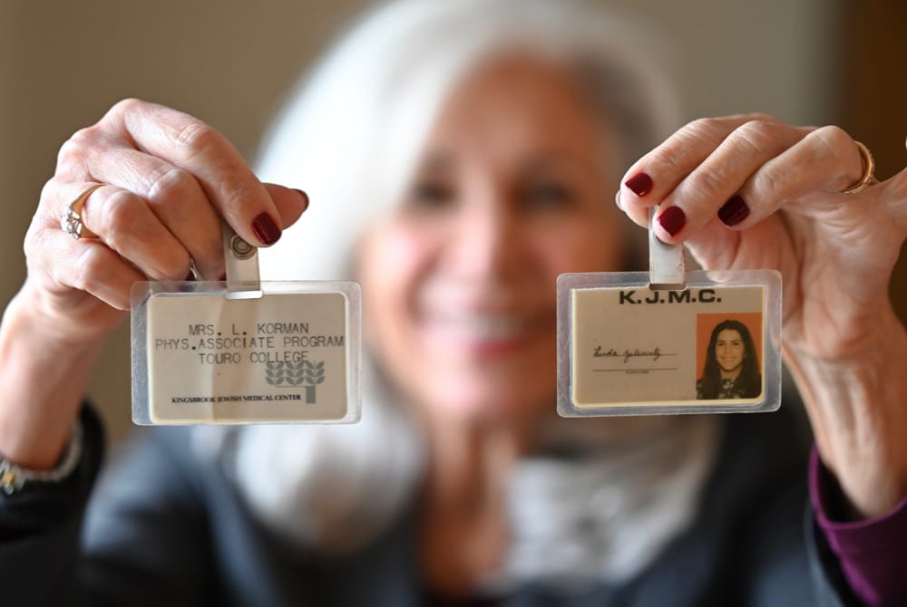 Linda Korman holding Touro ID cards