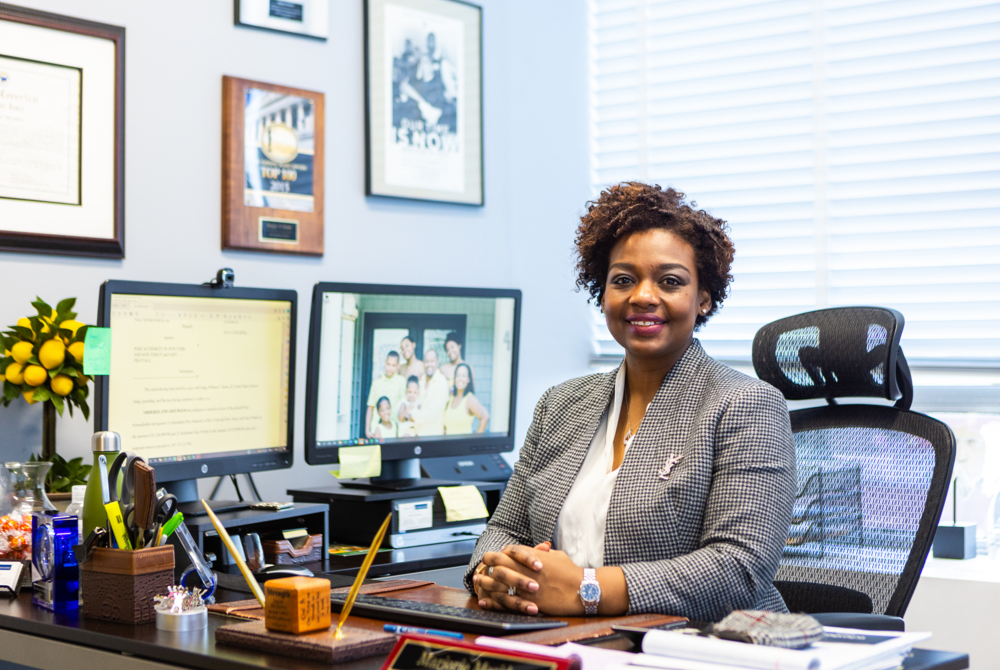 Marjorie Mesidor, an alumna of Touro Law Center, sitting by her desk. 