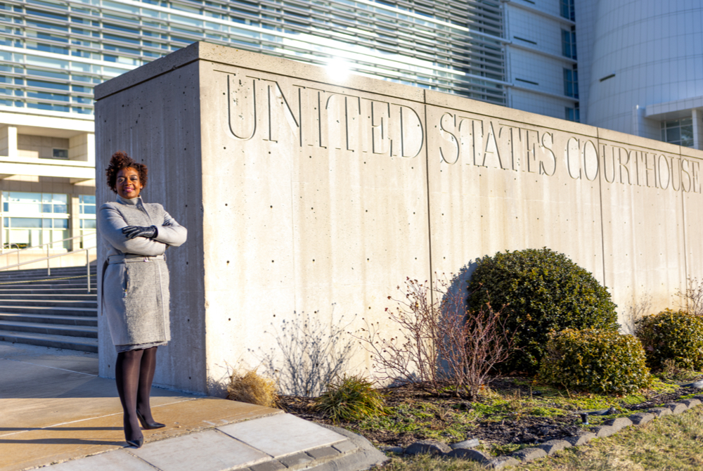 marjorie mesidor posing outside the united states courthouse